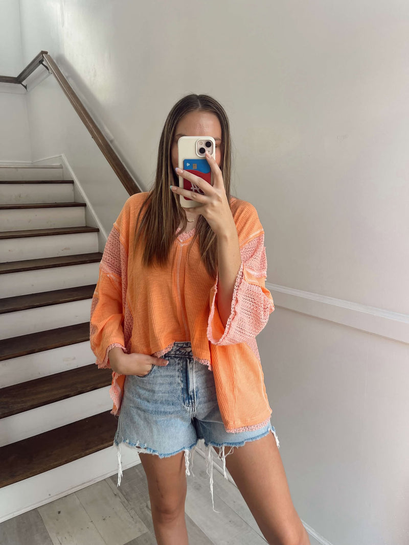 Oversize V-neck coral pink top